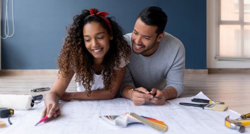 Couple reviewing blueprints