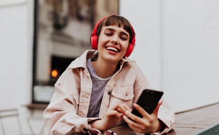 Young lady wearing red headphones
