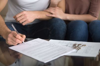 Couple signing paperwork
