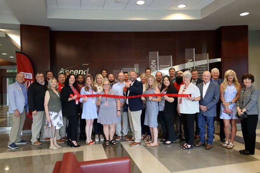 Ascend team and guests pose for ribbon cutting photo to celebrate Ascend Federal Credit Union's 75th anniversary