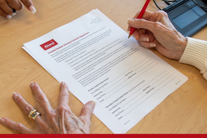 An elderly woman signs an advanced consent agreement