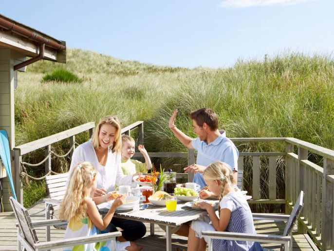 Family enjoying a meal on the back porch.