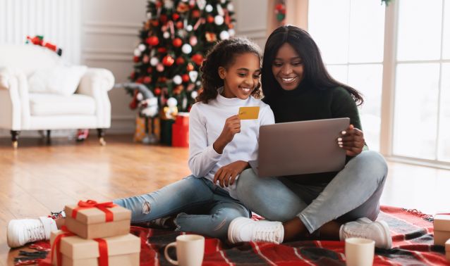 A mother and daughter shop online during the holidays.