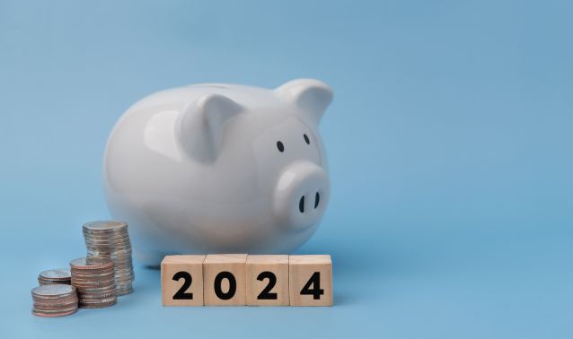 A piggy bank blocks that say 2024.