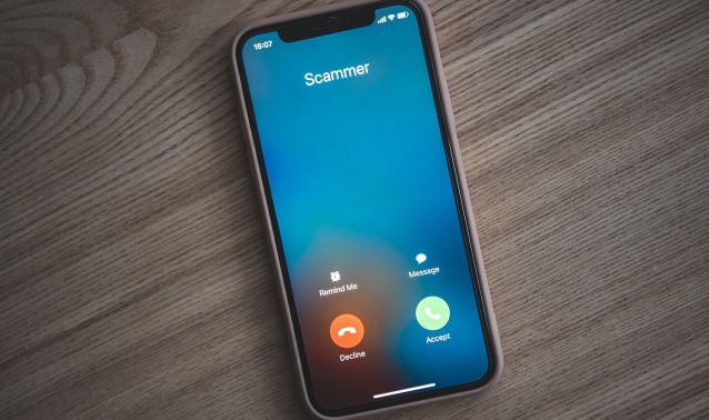 A phone showing a spam call.