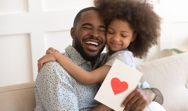 Young daughter hugs father