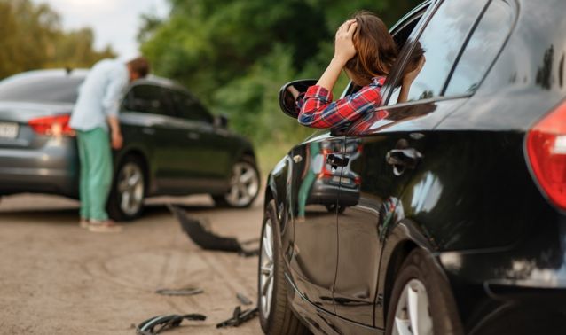 Woman looking at a car crash