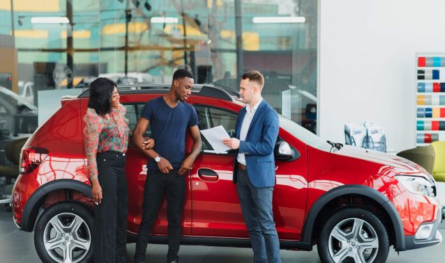 Couple buying car at dealership