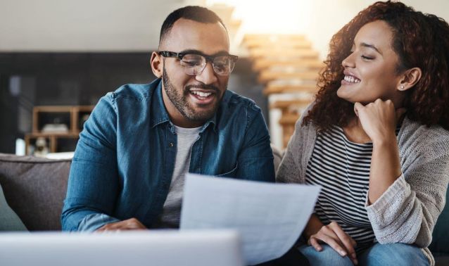 Couple reviewing paper in thought