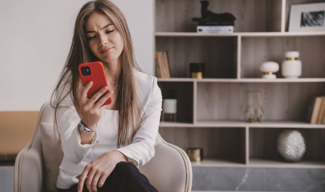 A woman looks at her phone.