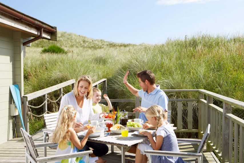 Family enjoying a meal on the back porch.