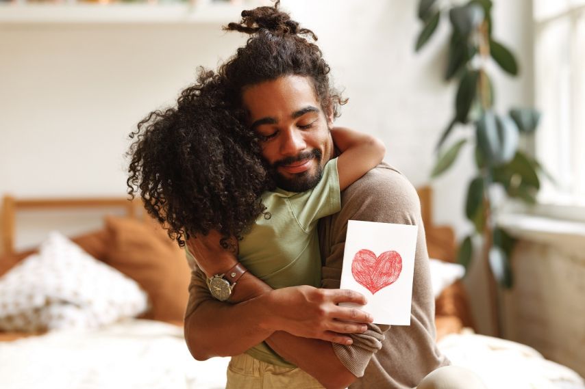 A father hugs his child.