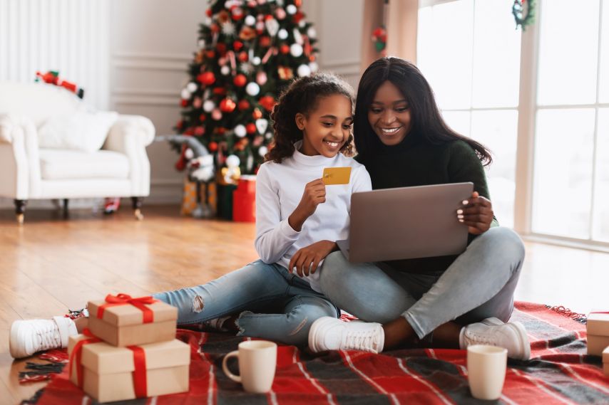 A mother and daughter shop online during the holidays.