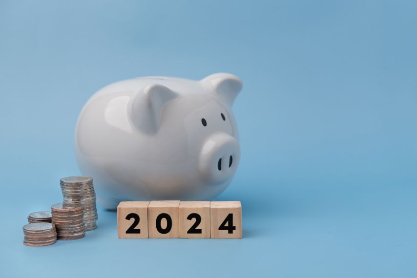 A piggy bank blocks that say 2024.