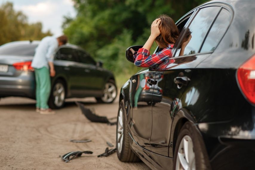 Woman looking at a car crash