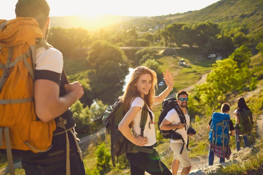 Hikers waving at camera.