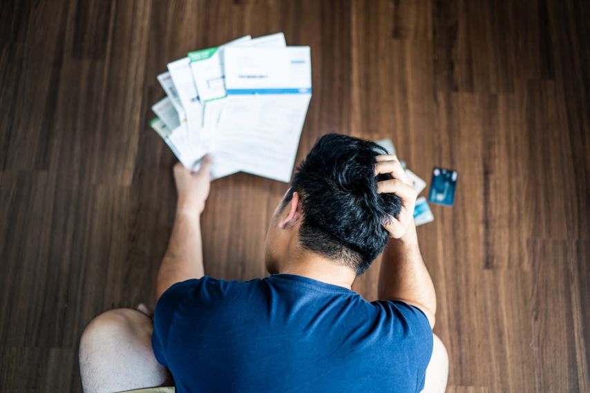 A man looks worringly at his bills