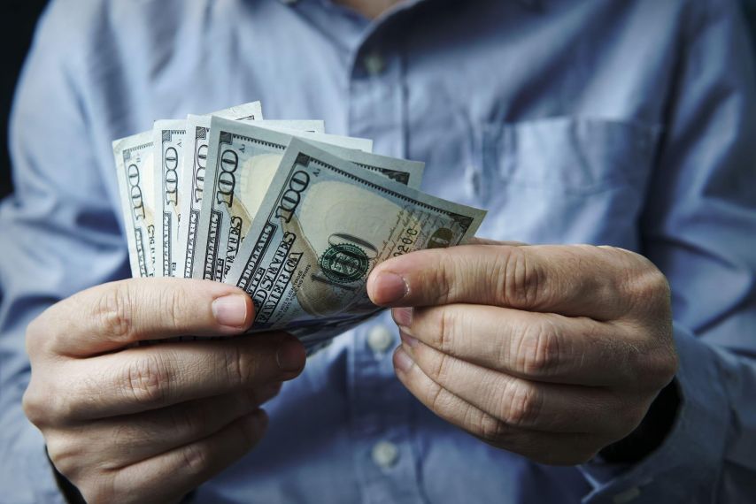 Hands holding cash.