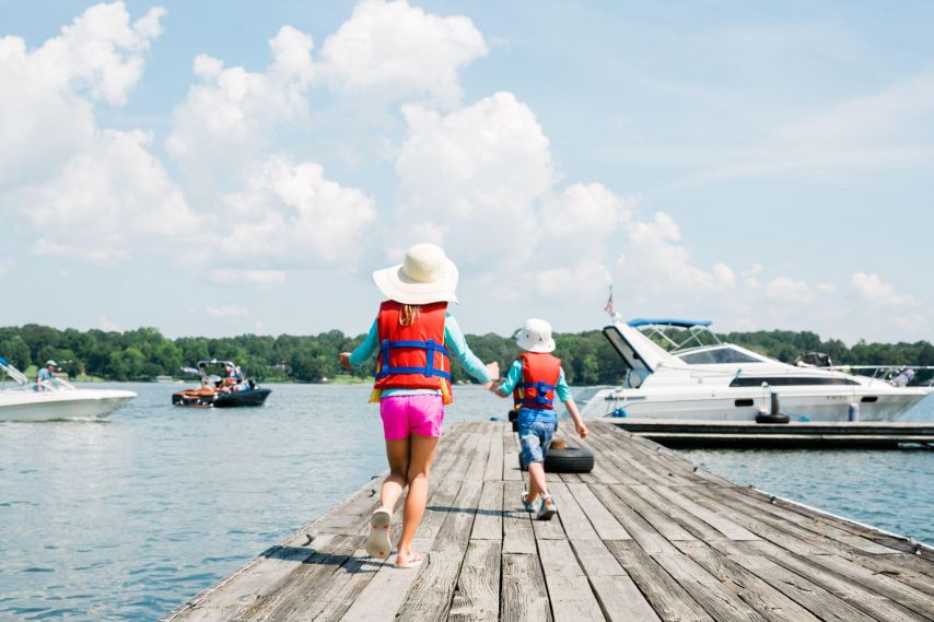 Children walking on a dock.