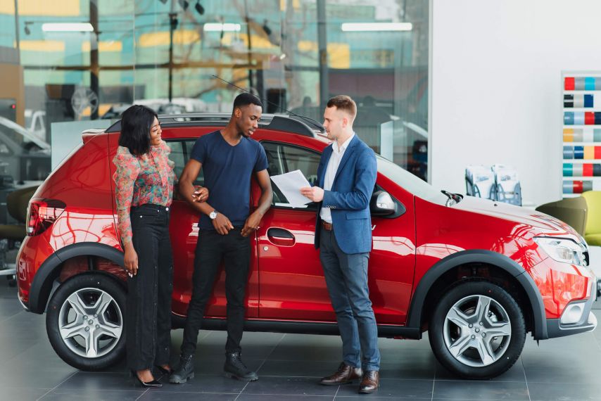 Couple buying car at dealership