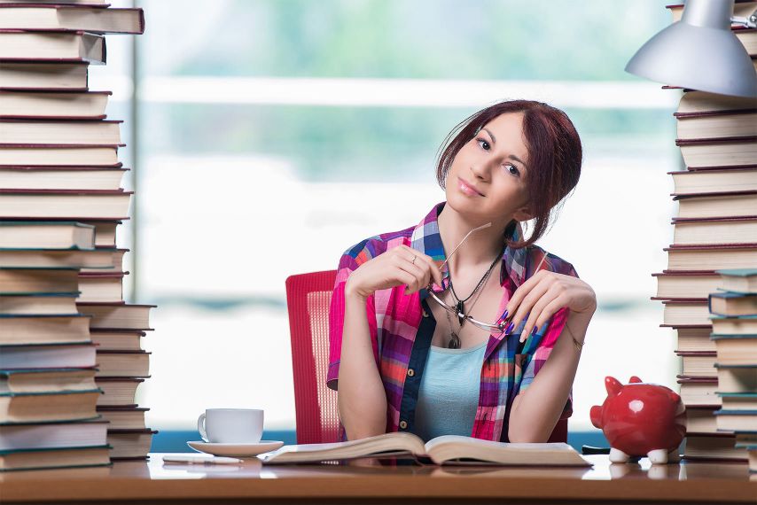 A student surrounded by books