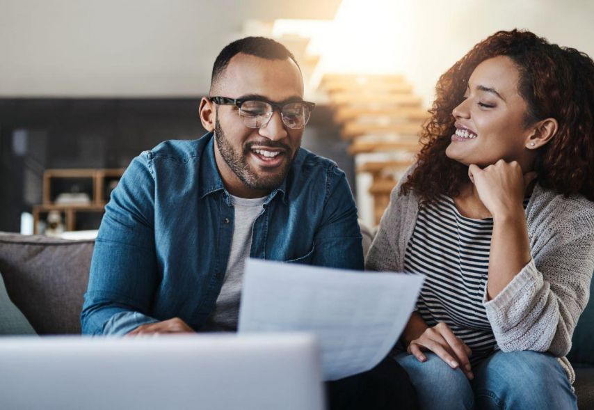 Couple reviewing paper in thought