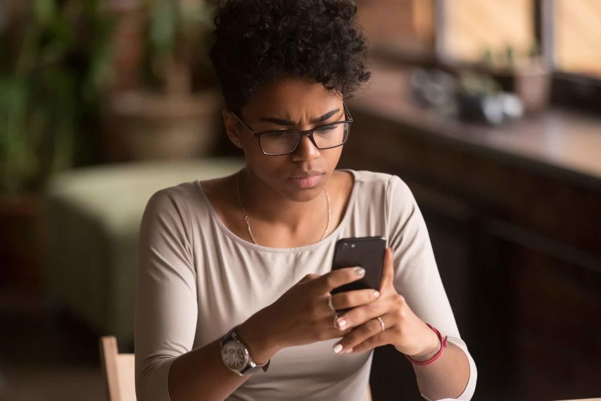 A woman looks at her phone.