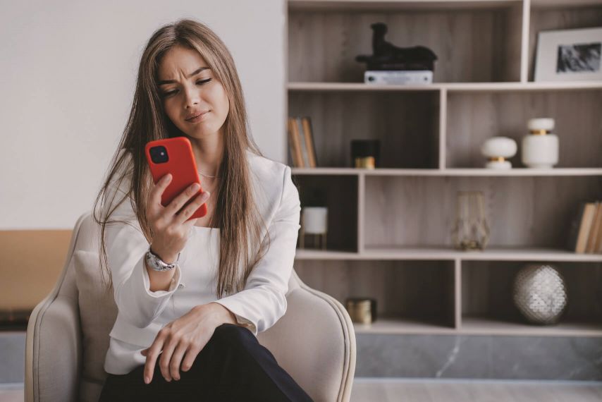 A woman looks at her phone.