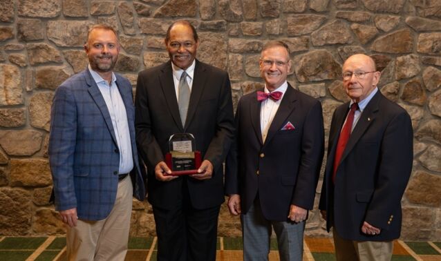 Anthony Taylor receives his Hall of Fame plaque and poses with Ascend CEO Matt Jernigan