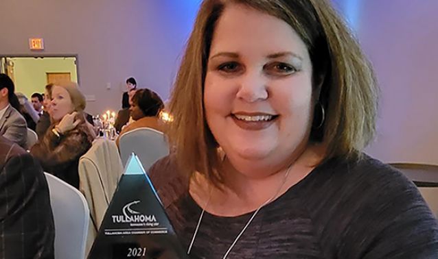 Amy taylor posing with award