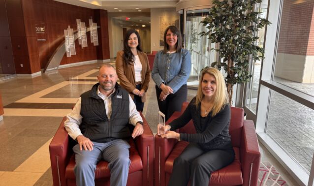 Ascend team members smile and pose for photo with MVP Training Award