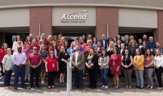 Ascend employees pose in front of corporate headquarters