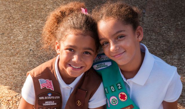 Two girl scouts smiling