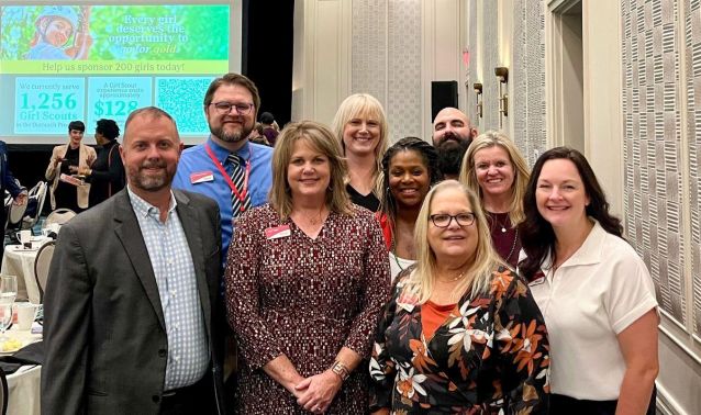 Ascend employees smiling for group photo at Girl Scouts luncheon