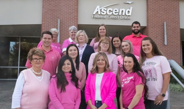 Ascend employees stand outside corporate headquarters wearing pink