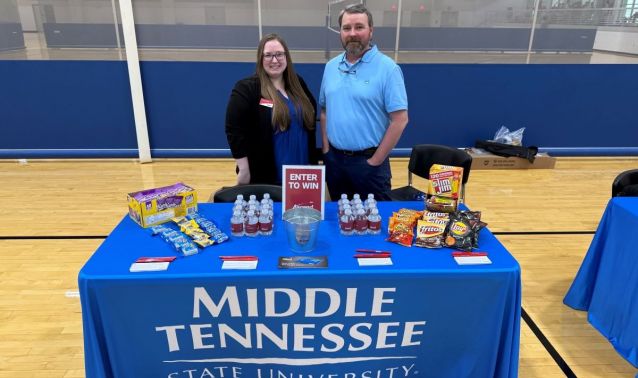 Ascend employees pose at MTSU Financial Literacy Month event.