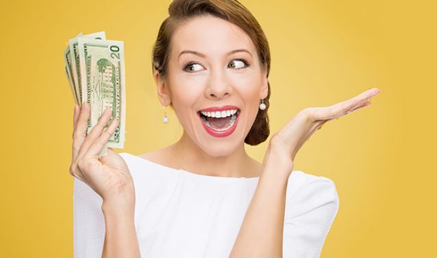 Woman smiling with money in hand