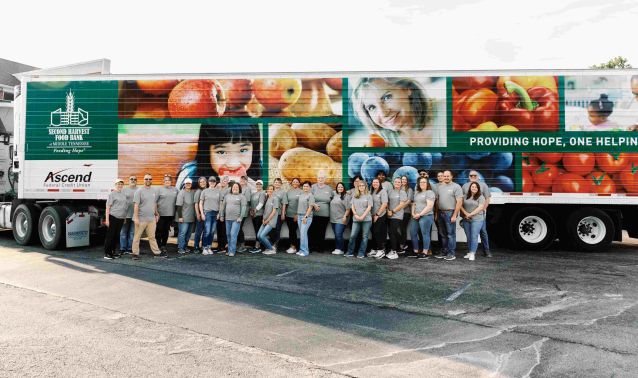 Ascend leadership poses in front of second harvest food truck