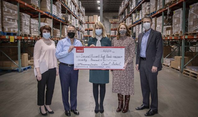 Ascend board members and CEO present second harvest food bank with a check.