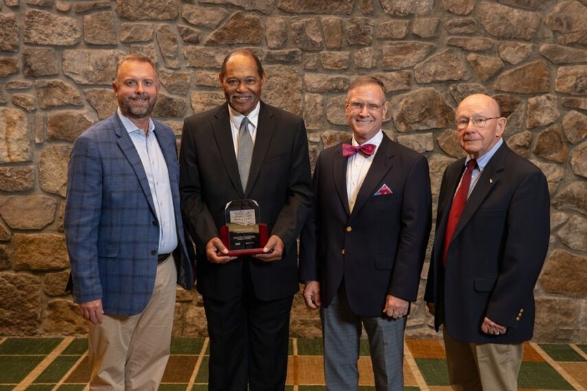 Anthony Taylor receives his Hall of Fame plaque and poses with Ascend CEO Matt Jernigan