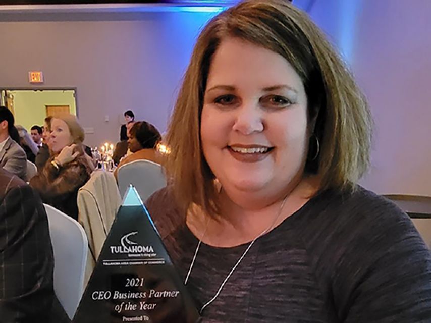 Amy taylor posing with award