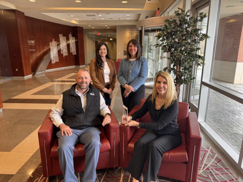 Ascend team members smile and pose for photo with MVP Training Award