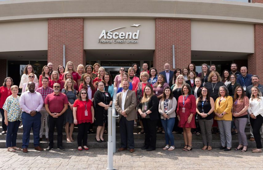 Ascend employees pose in front of corporate headquarters