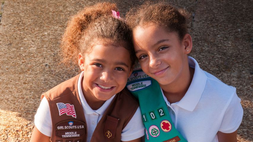 Two girl scouts smiling