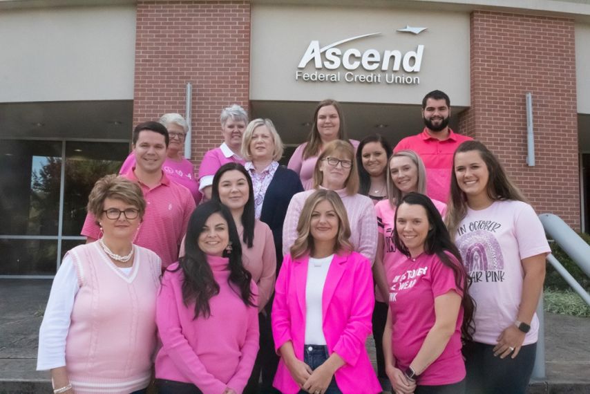 Ascend employees stand outside corporate headquarters wearing pink