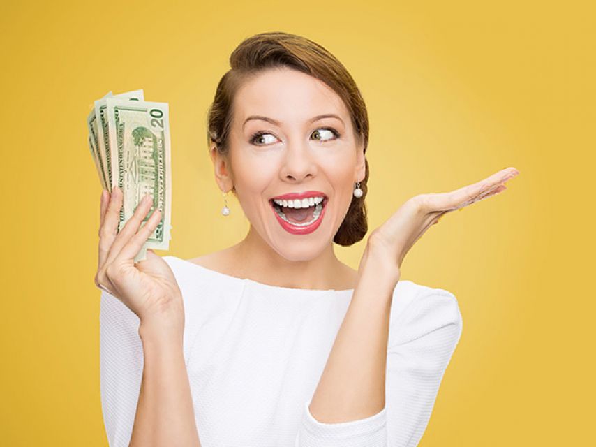 Woman smiling with money in hand