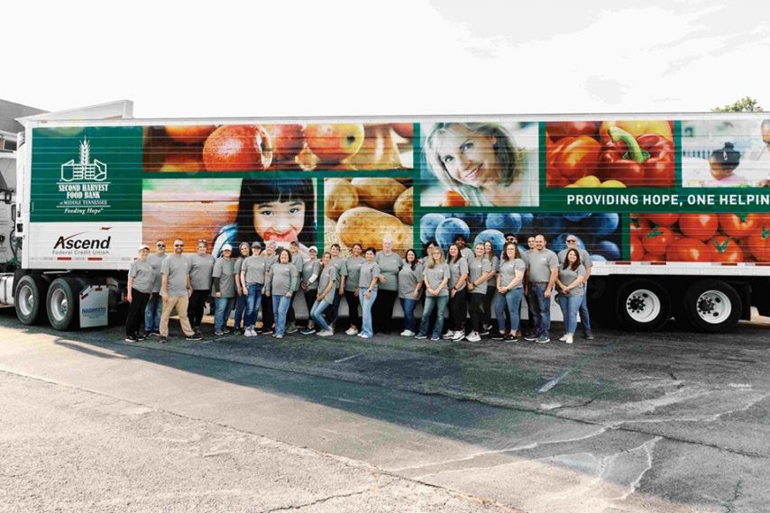 Ascend leadership poses in front of second harvest food truck