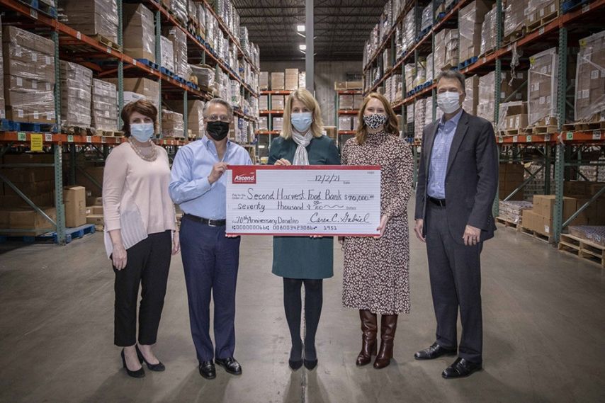 Ascend board members and CEO present second harvest food bank with a check.