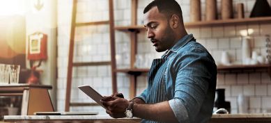 Man using his tablet in coffee shop