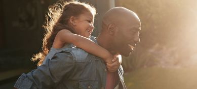 Father carrying his daughter on his back